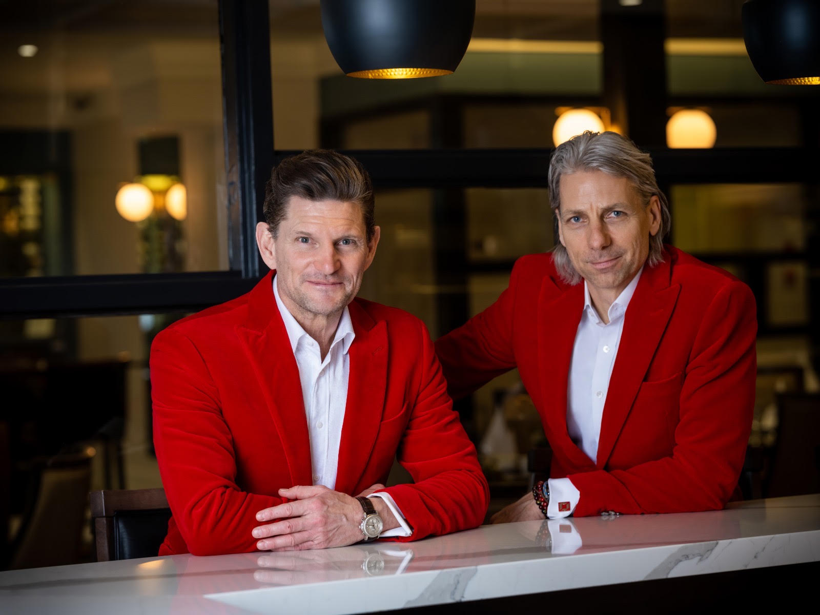 Ken McCord and Dave Sanderson in red jackets at the bar
